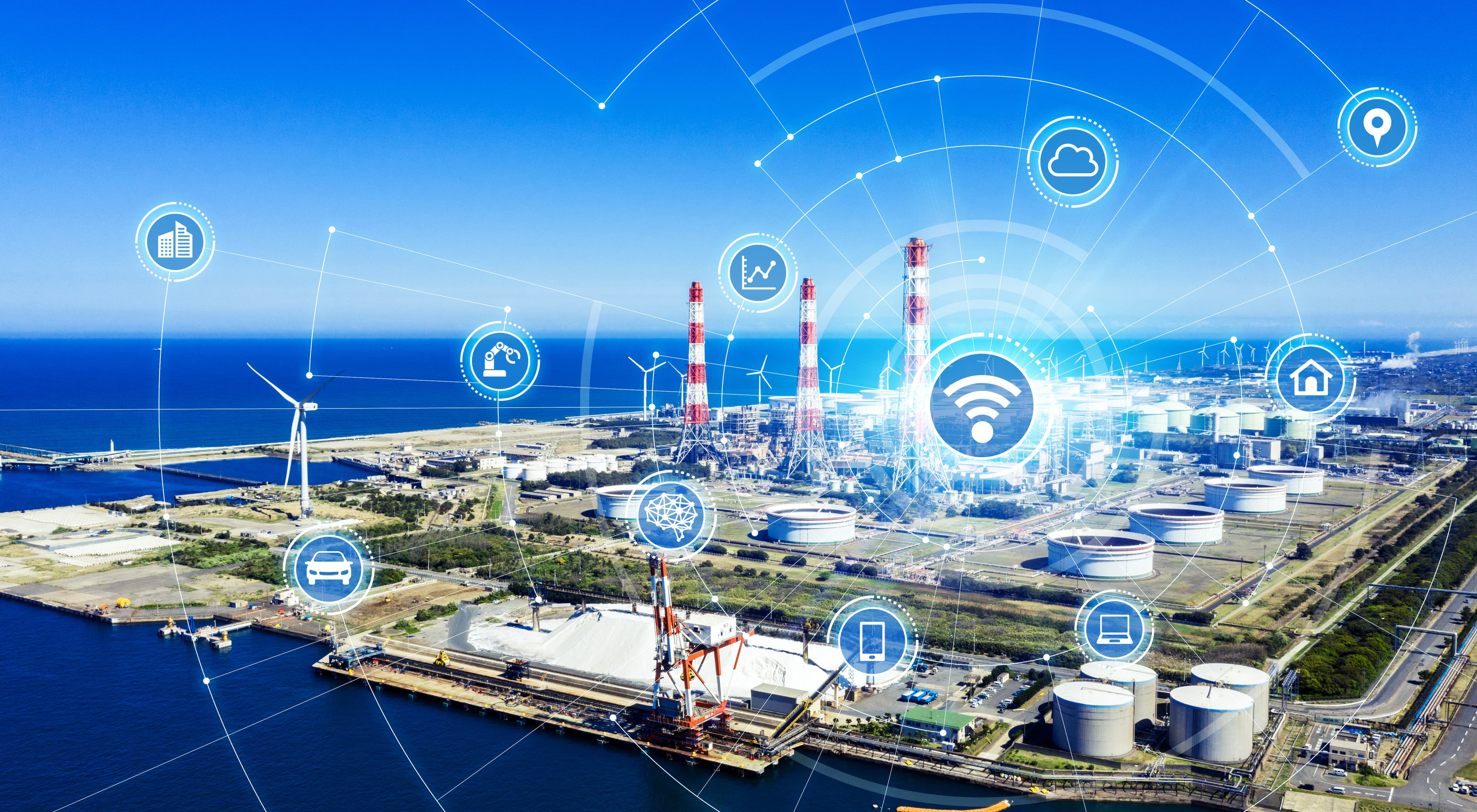 Aerial view of an industrial plant connected through IoT and data network overlays